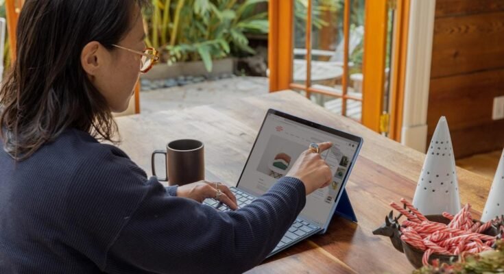 A woman engaged with a laptop utilizing account planning software.